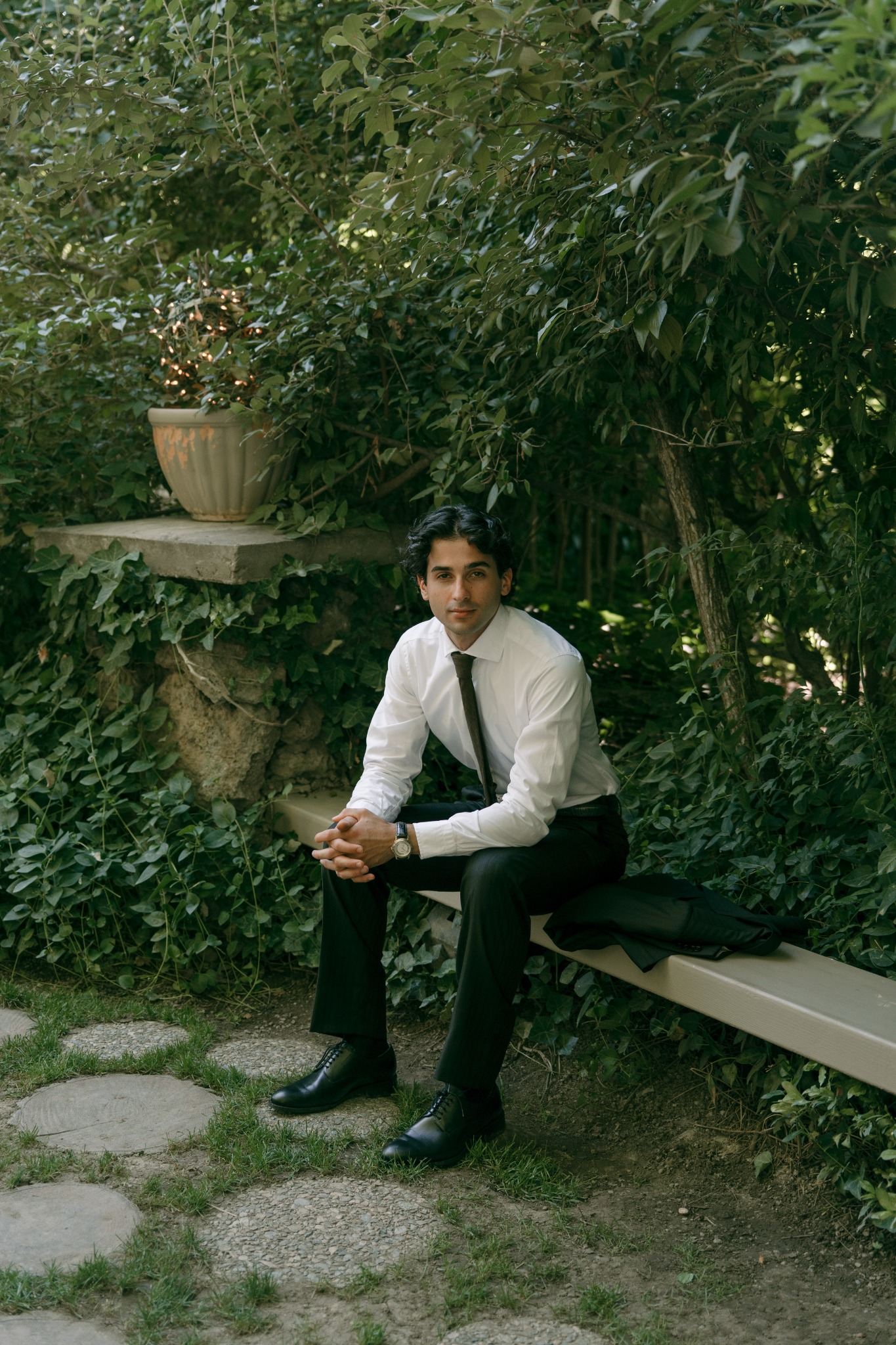 Riccardo Nastasi seated in a leafy garden